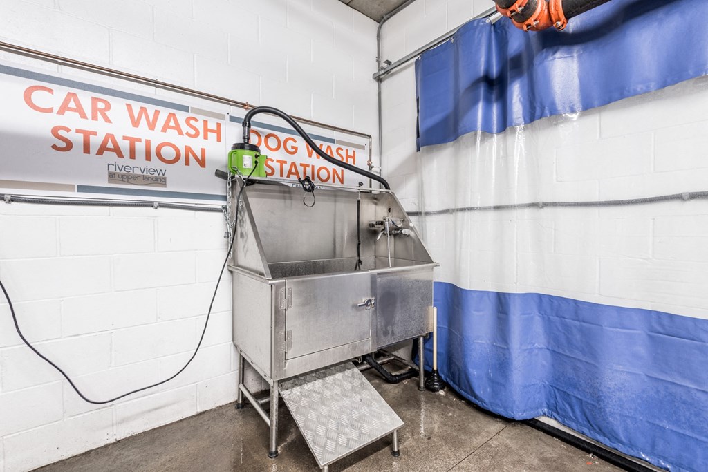 a car wash station in a garage with a blue and white curtain