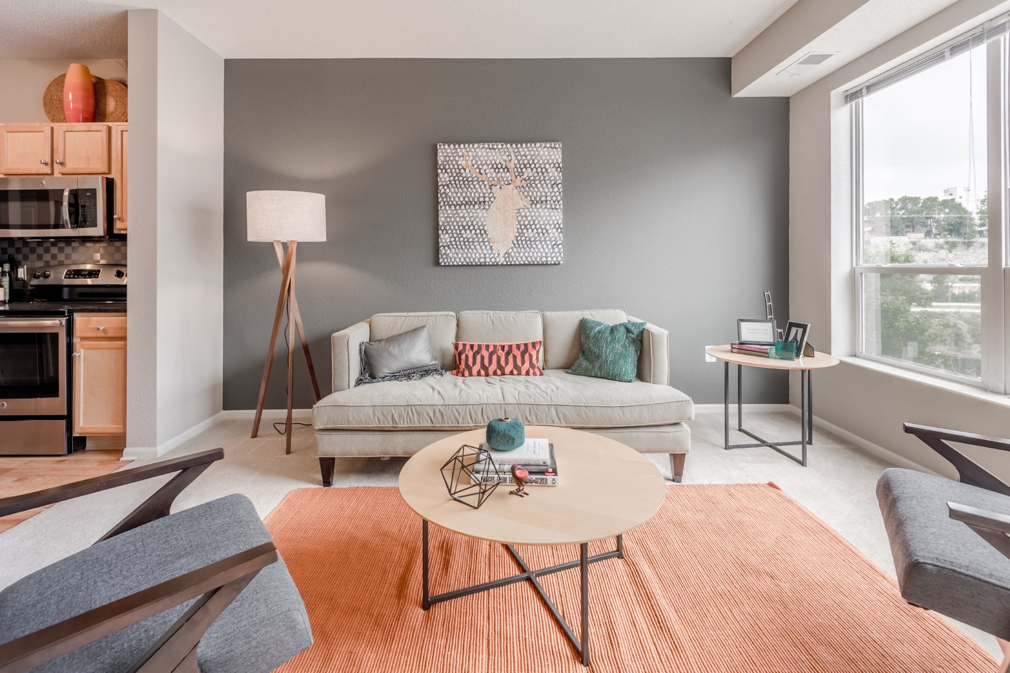 Living room with couch, chairs, and rug