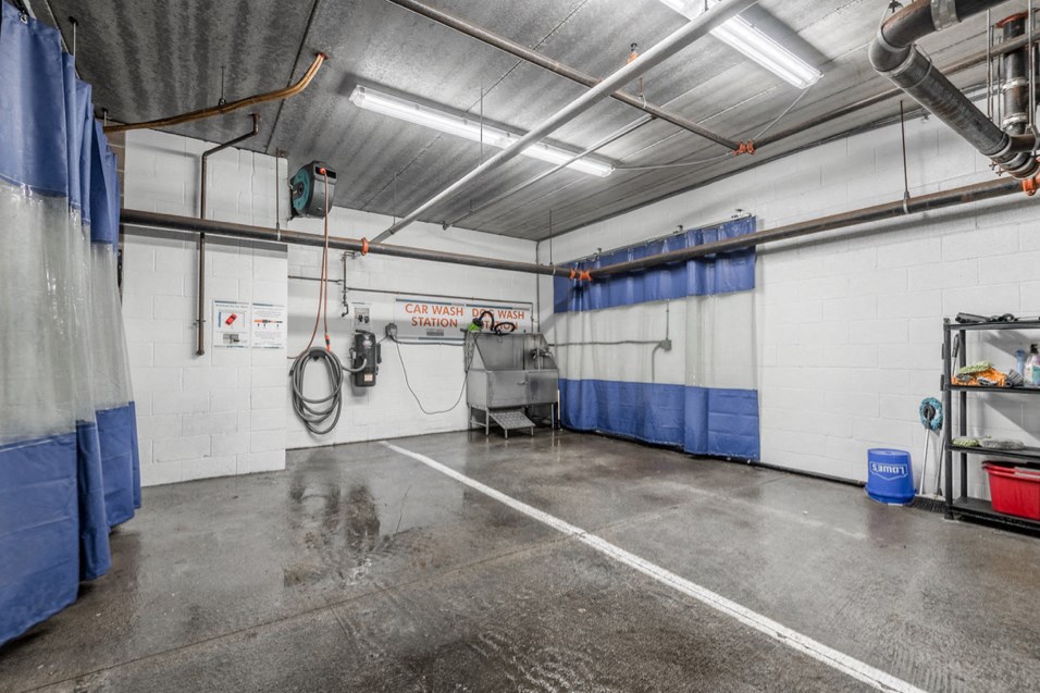 the interior of a garage with white walls and blue curtains