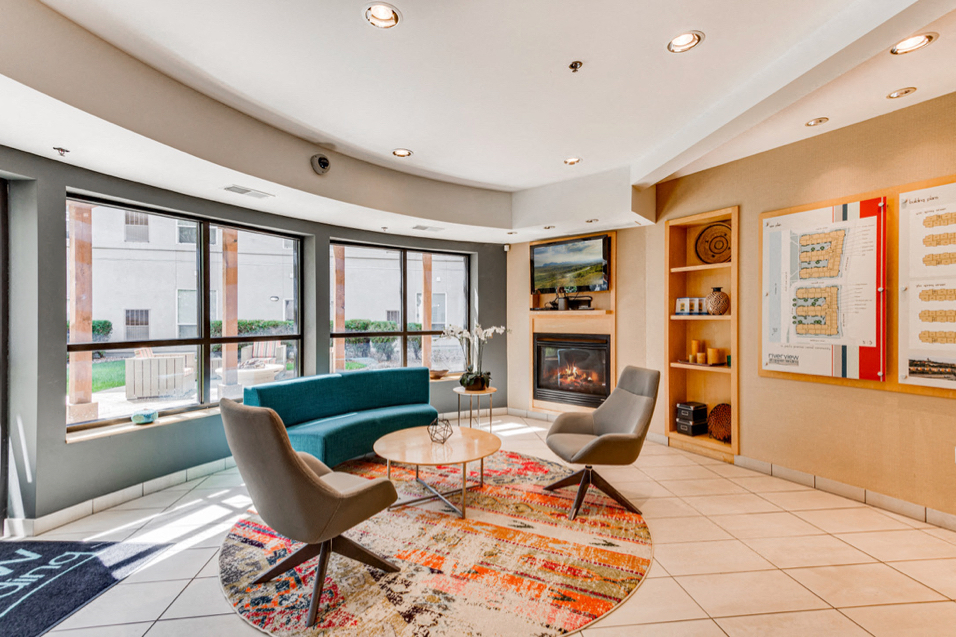 Circular community room with chairs, tables, and fireplace