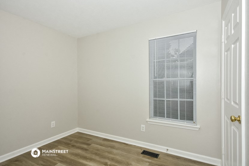 the bedroom of the bridgewater condos with a window and wood flooring