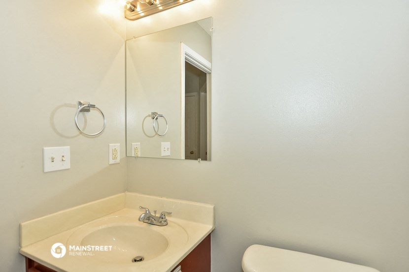 a bathroom with a sink and a mirror and a toilet