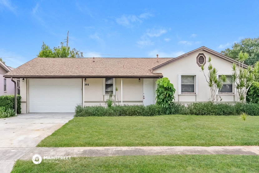 a white house with a lawn in front of it