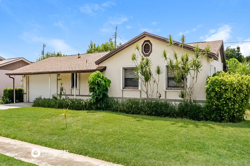 a white house with a lawn in front of it