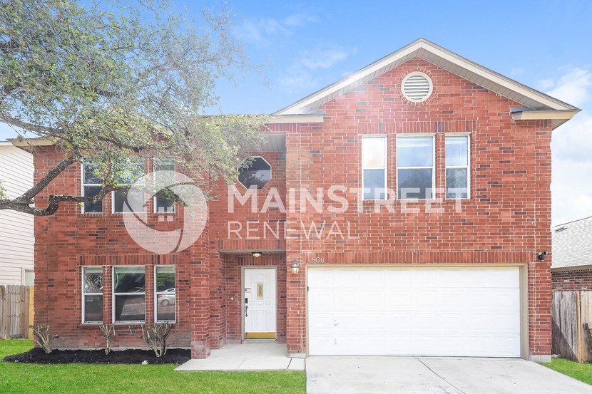 a red brick house with a mural on the side of it