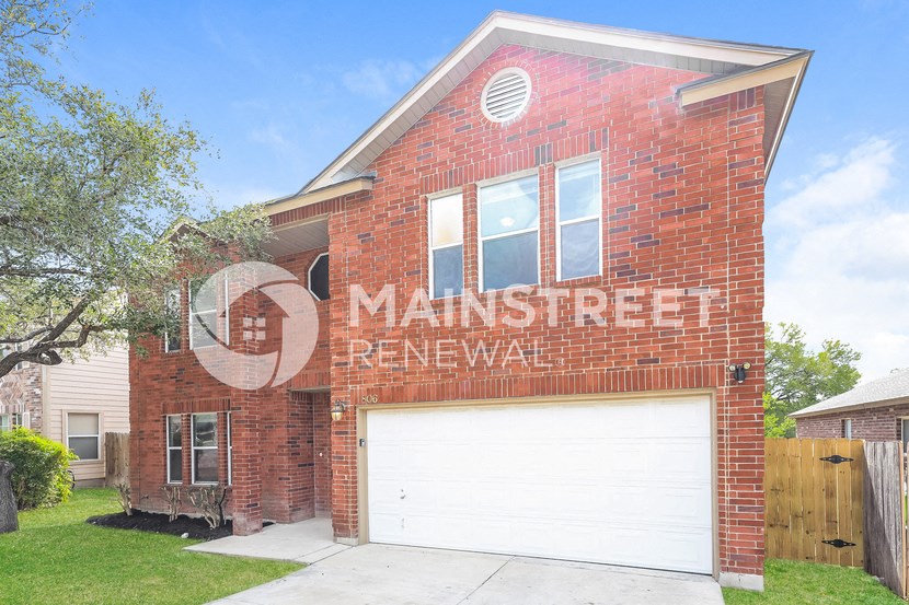 a red brick house with a white garage door