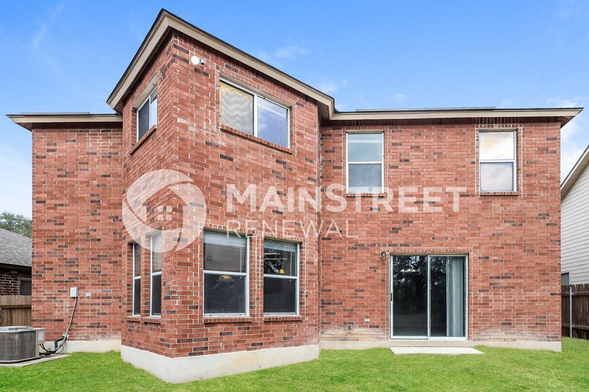 the side of a brick building with a mural on it