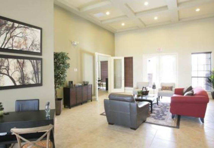a living room with couches and chairs and a table