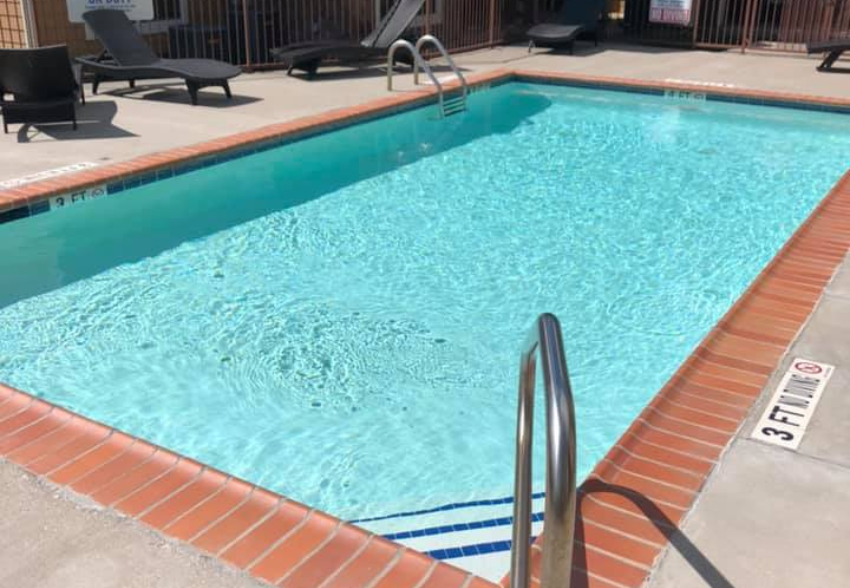 a large swimming pool in a hotel with a ladder