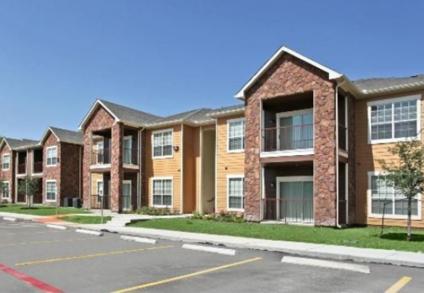 an apartment building with a street in front of it