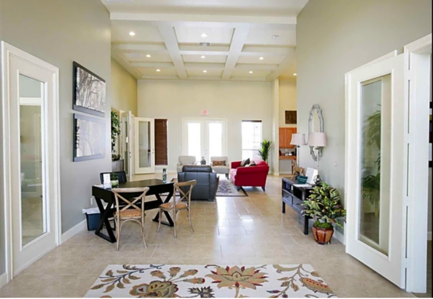 a living room with a table and chairs and a couch