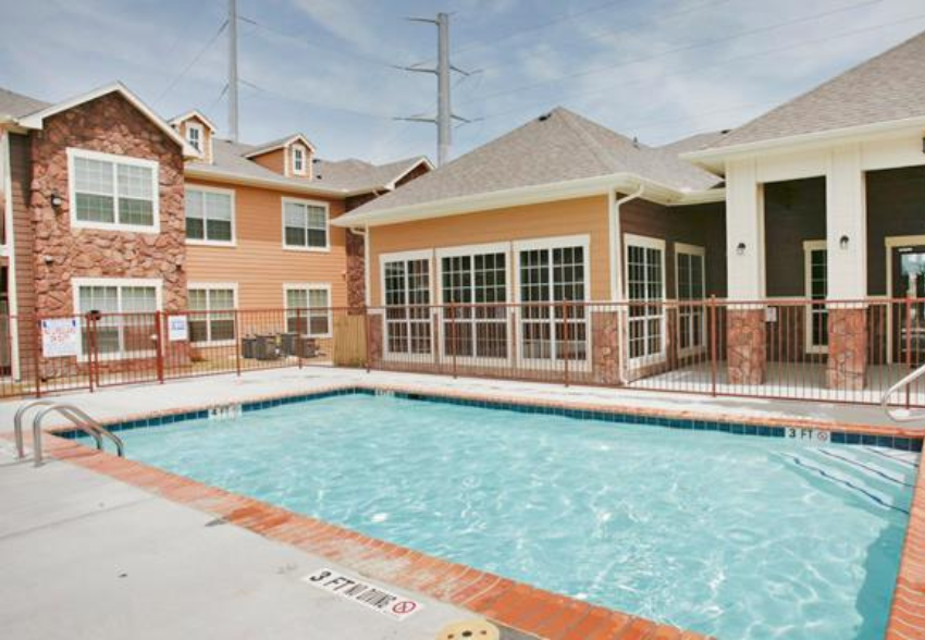 a swimming pool in front of a building