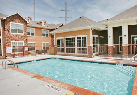 a swimming pool in front of a building