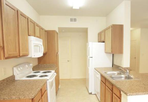 a kitchen with a stove refrigerator and a sink