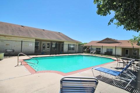 our resort style swimming pool is next to our building with chairs