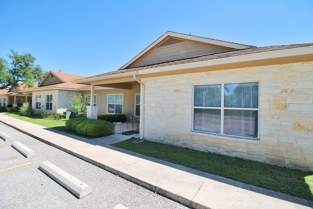 a yellow house with a sidewalk in front of it