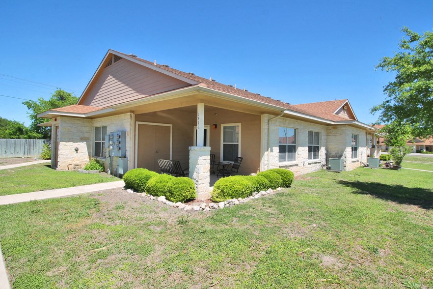 the front of a house with a lawn and a porch