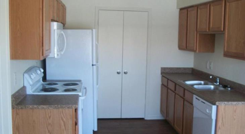 a kitchen with a stove and a refrigerator