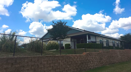 a house with a fence in front of it