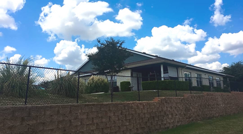 a house with a fence in front of it