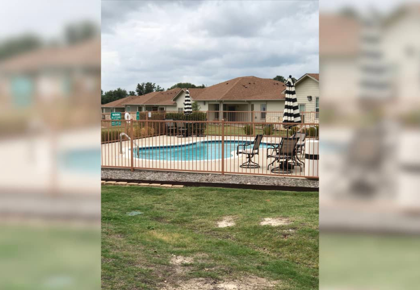 the backyard of a house with a swimming pool
