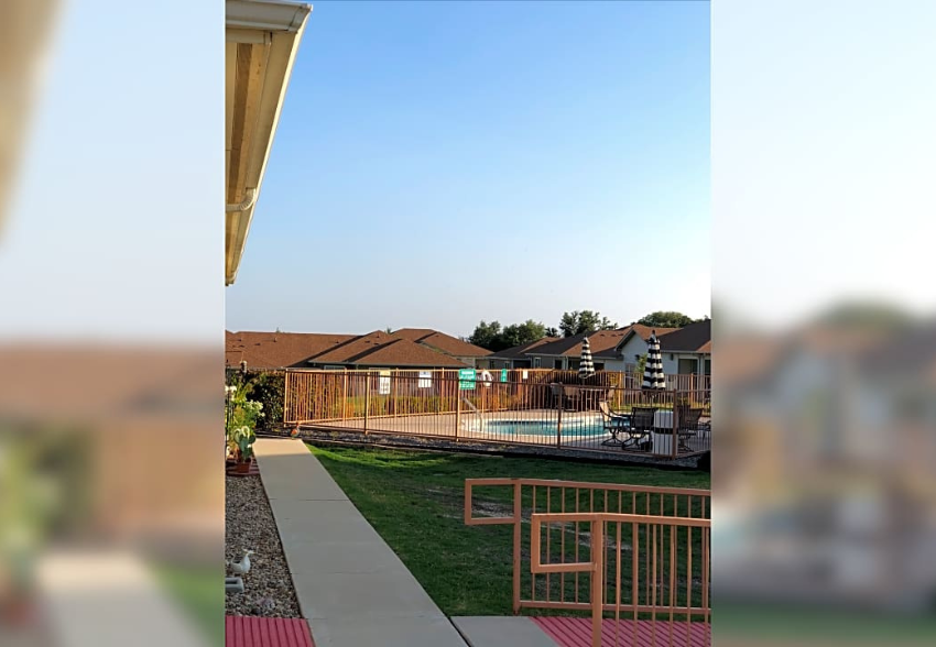 a backyard with a pool and a fence
