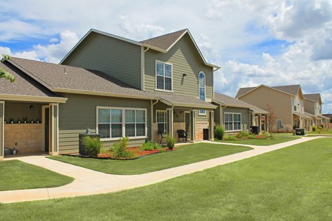 a row of houses with a lawn in front of them