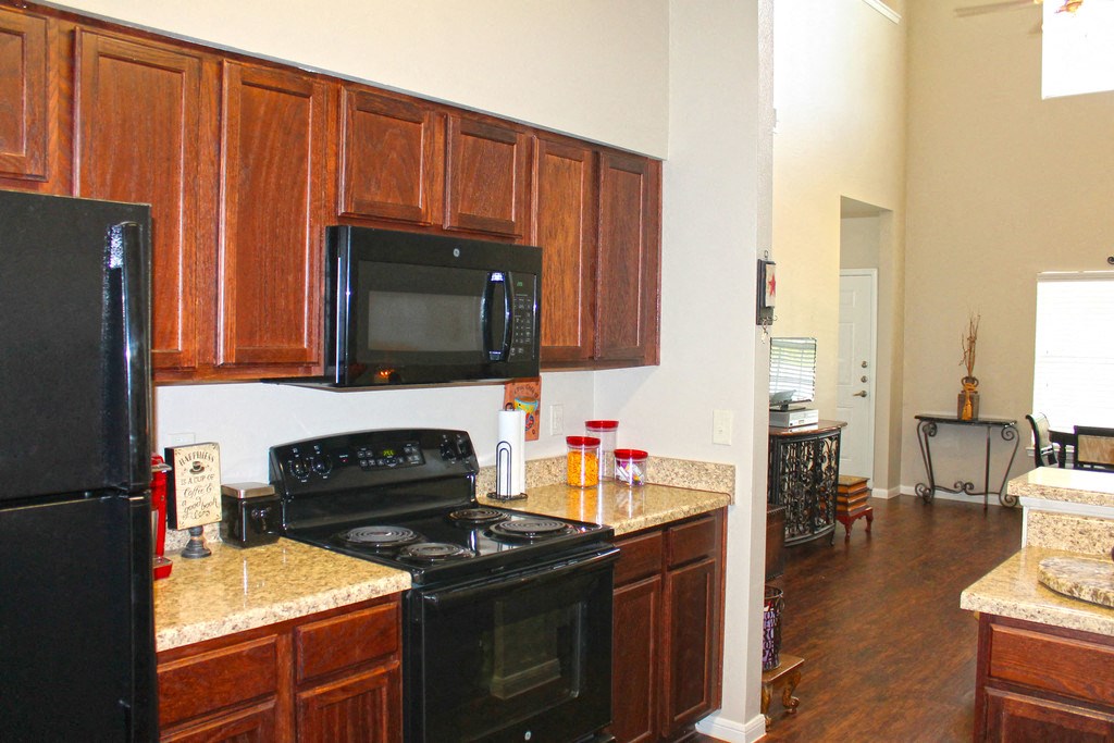 a kitchen with black appliances and granite counter tops