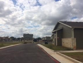 a church and a house on the side of a road