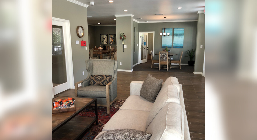 a living room and dining room with a couch and chairs