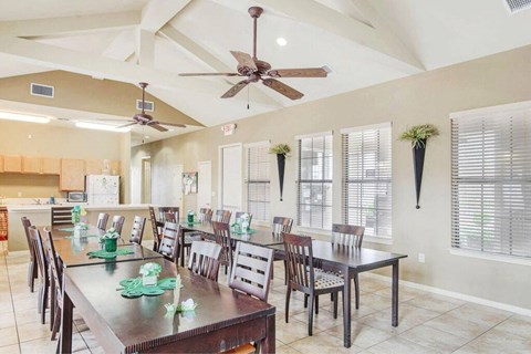 a large dining room with a table and chairs
