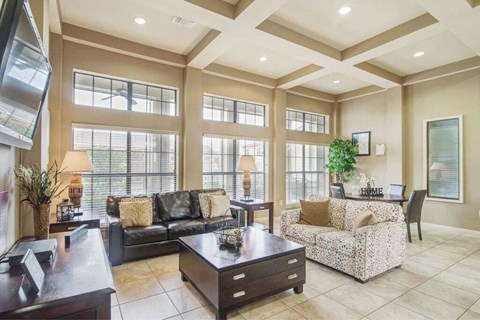 a large living room with a couch and a table