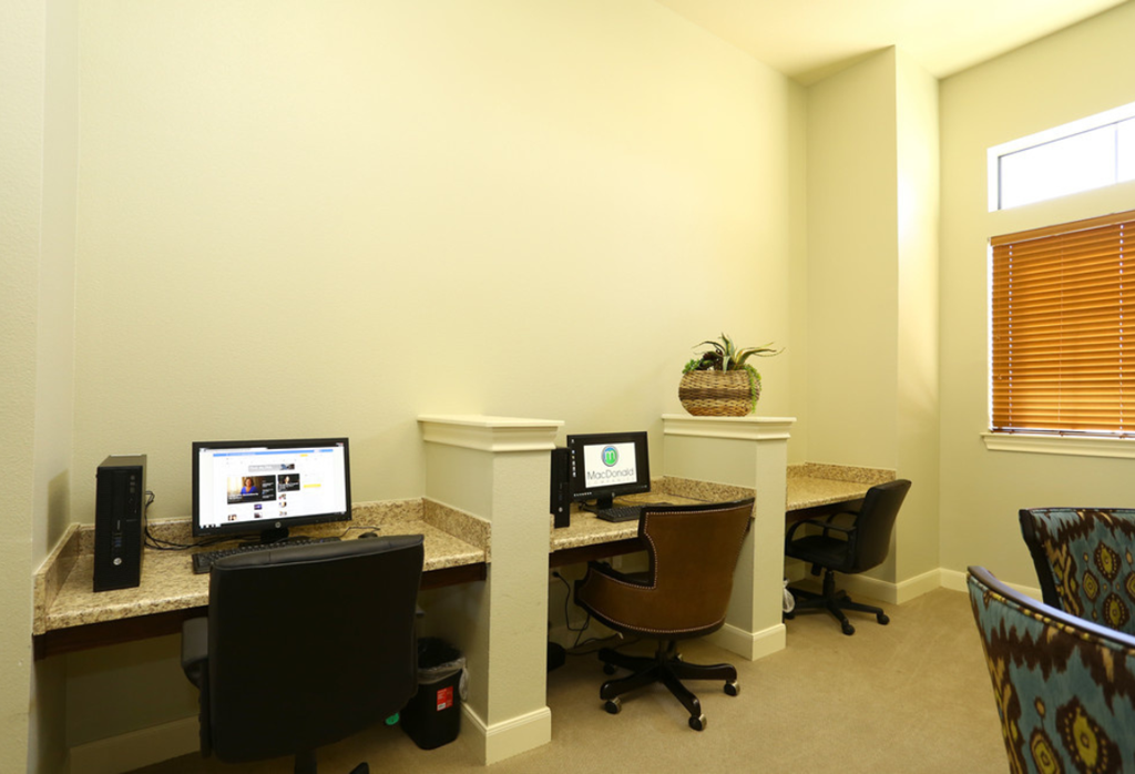 a home office with two desks and two computers