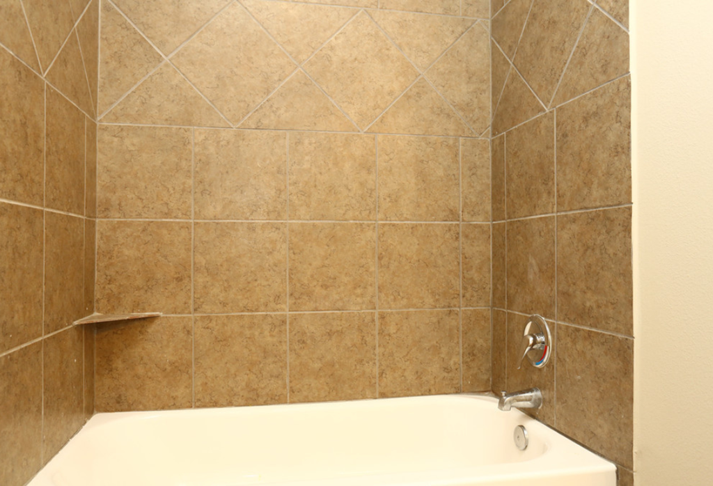 a bathroom with a shower and a bath tub