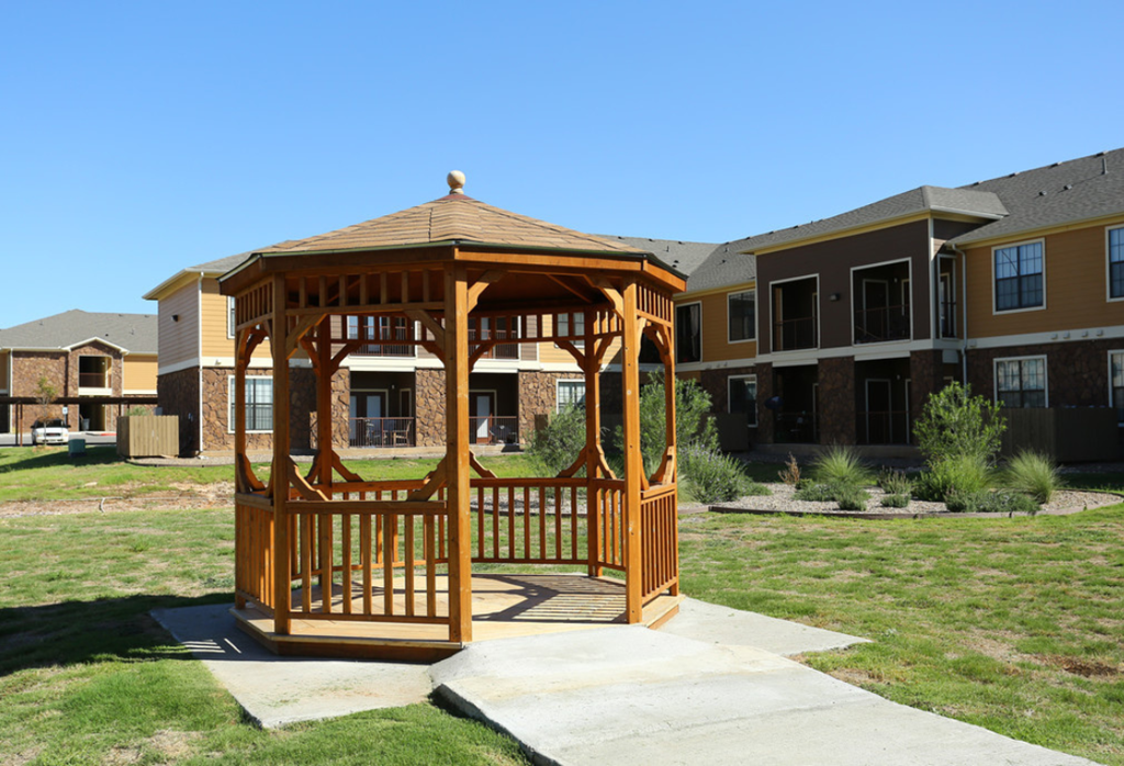 a gazebo in front of an apartment complex