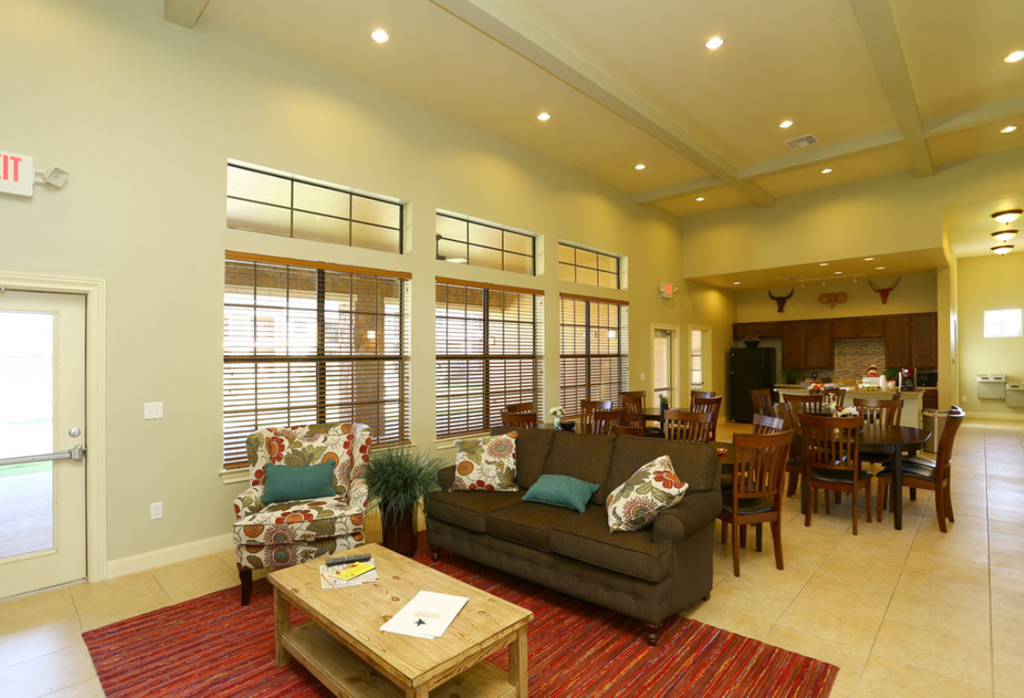 a living room and dining room with a couch and a table