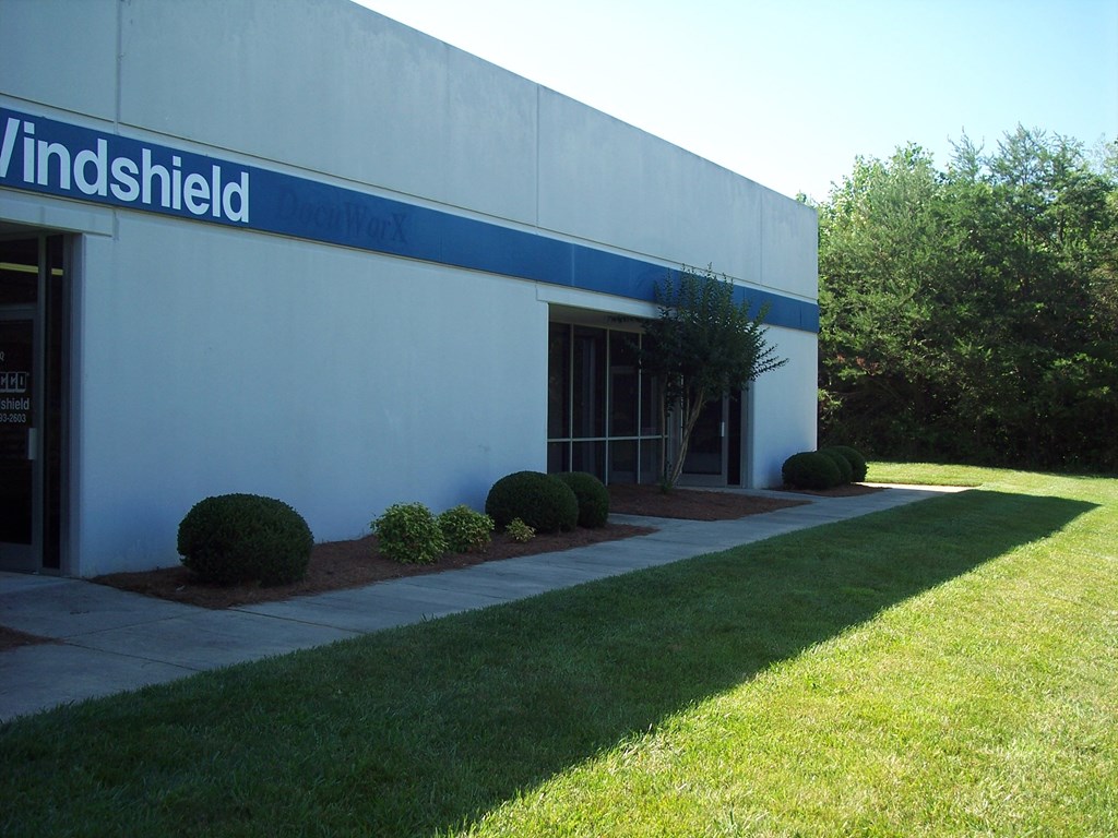 a white building with a blue sign on the side of it
