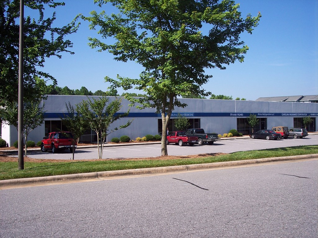 a building with cars parked in front of it on a street