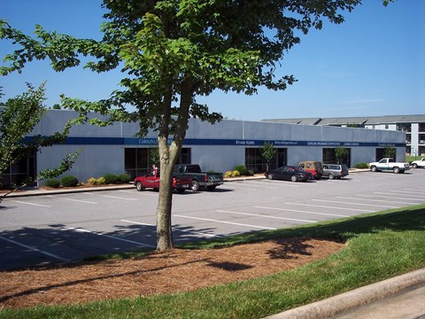 a parking lot with cars in front of a building