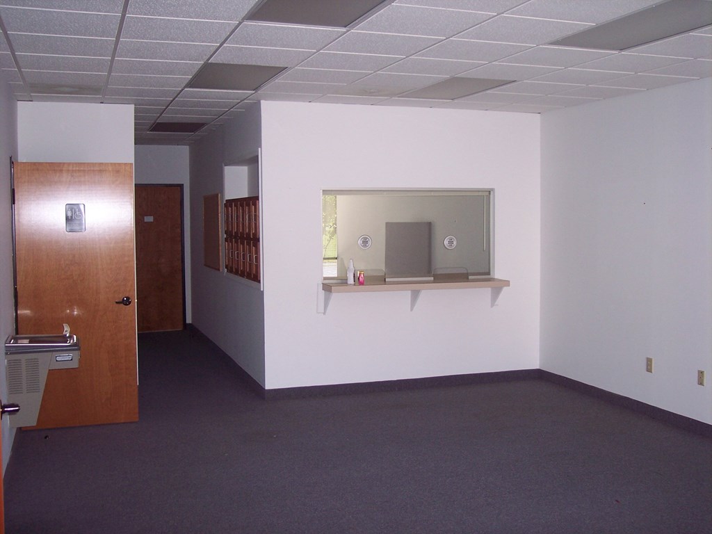 an empty room with a mirror and a door