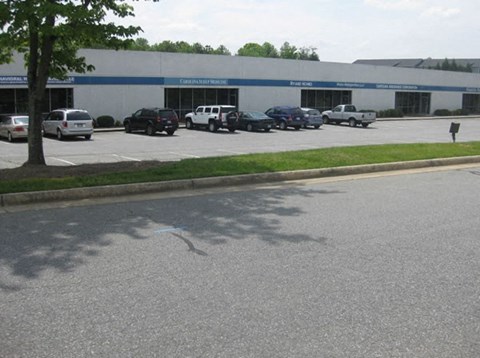 a parking lot with cars parked in front of a building