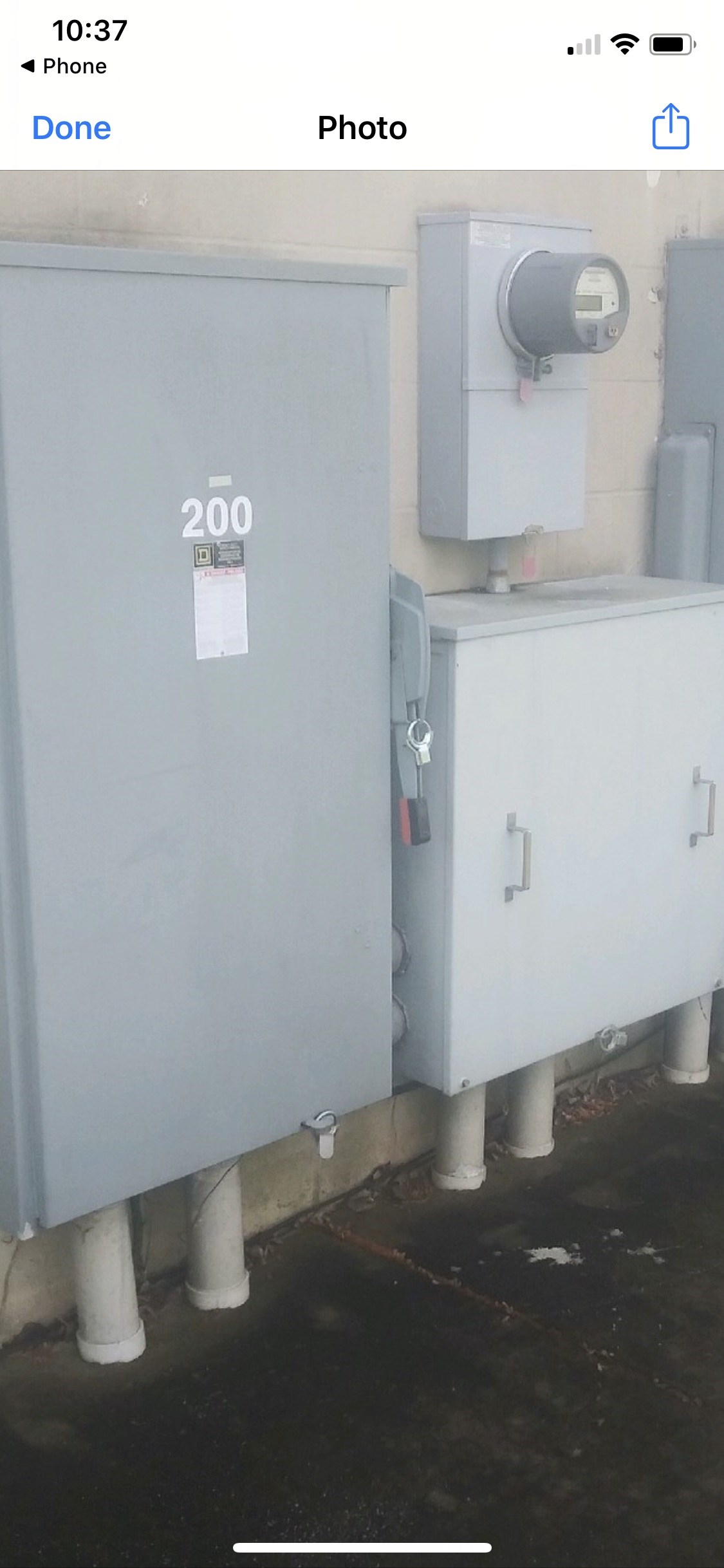A grey electrical box with the number 200 on it.