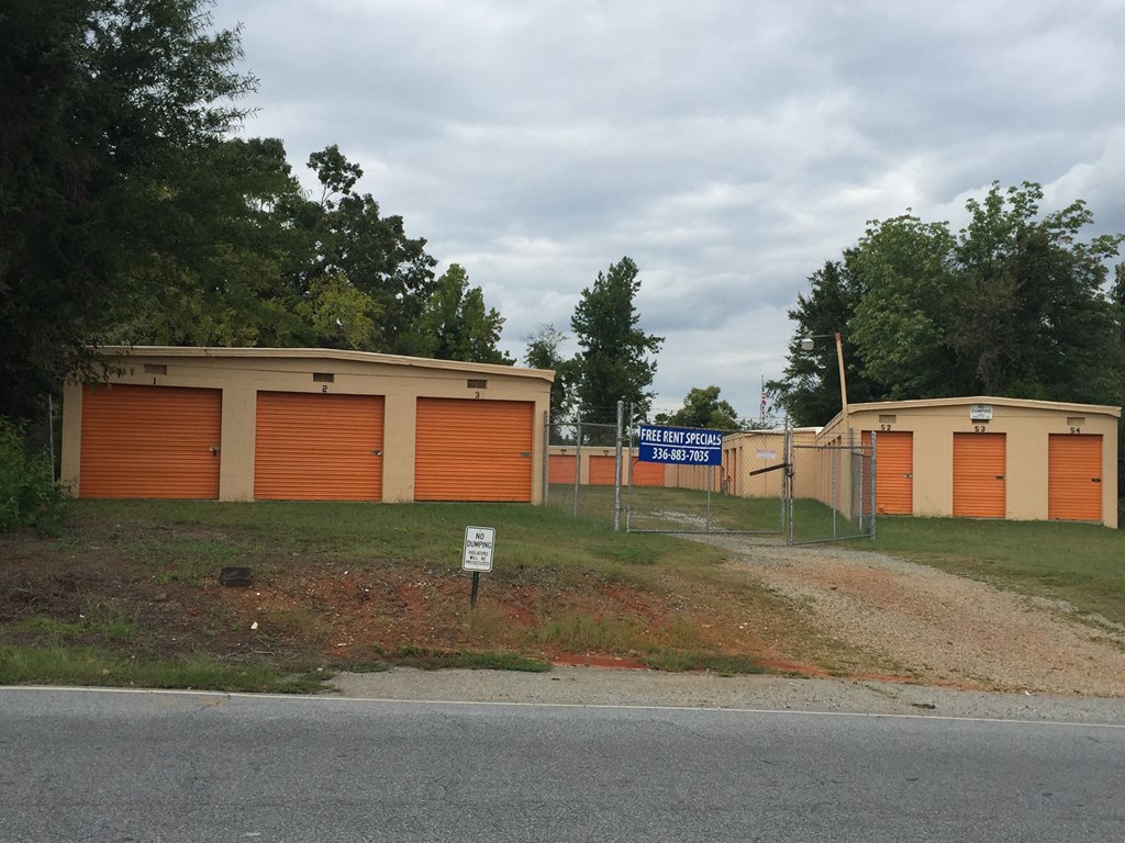 a building with two garages and a street sign in front of it