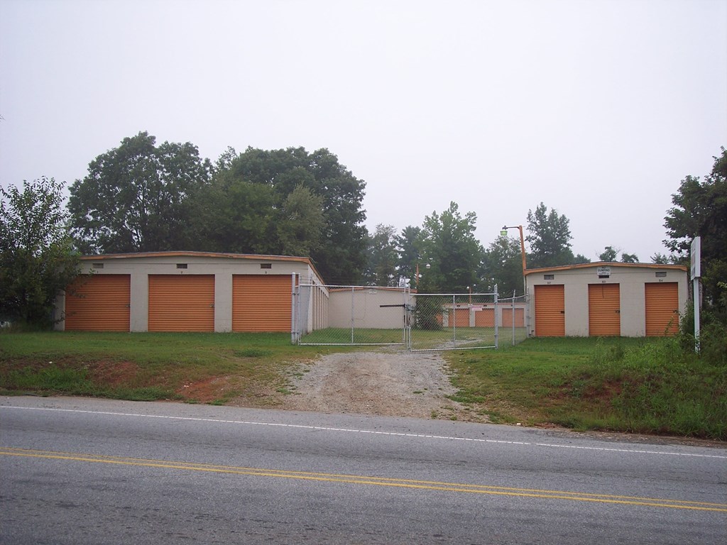 a building with two garages on the side of the road