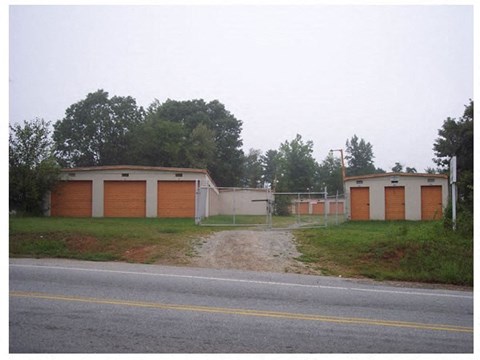 a building with two garages on the side of a road
