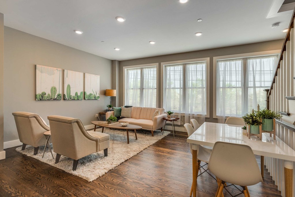 a living room with couches and chairs and a table