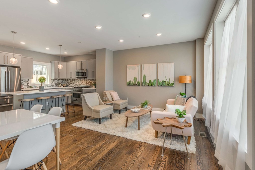 an open living room and kitchen with a table and chairs