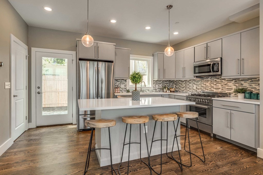 a kitchen with an island and three stools