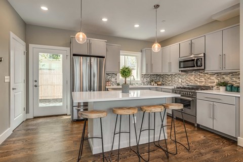 a kitchen with an island and three stools