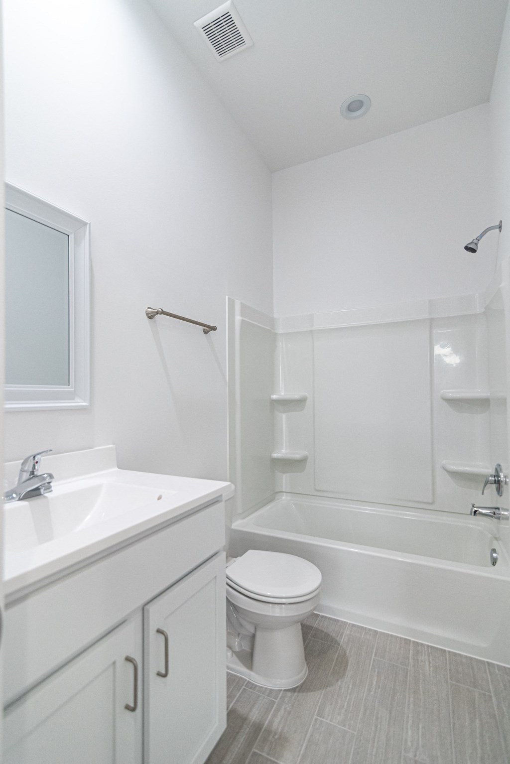 a bathroom with a toilet and a sink and a shower